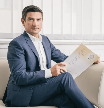 CEO and founder of the company, Valerij Torejev, in a business suit holding an Agriwell document